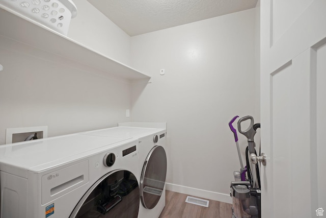 825 S 1710 E, Spanish Fork, UT 84660 - clothes washing area with laundry area, baseboards, a textured ceiling, separate washer and dryer, and light wood-style flooring
