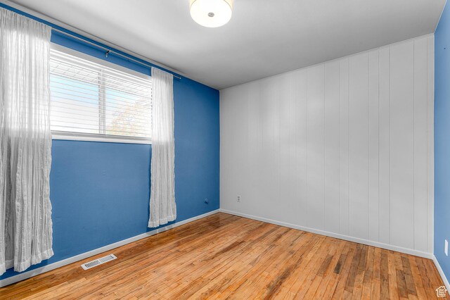 6888 S 455 E, Midvale, UT 84047 - unfurnished room with baseboards, hardwood / wood-style floors, and visible vents