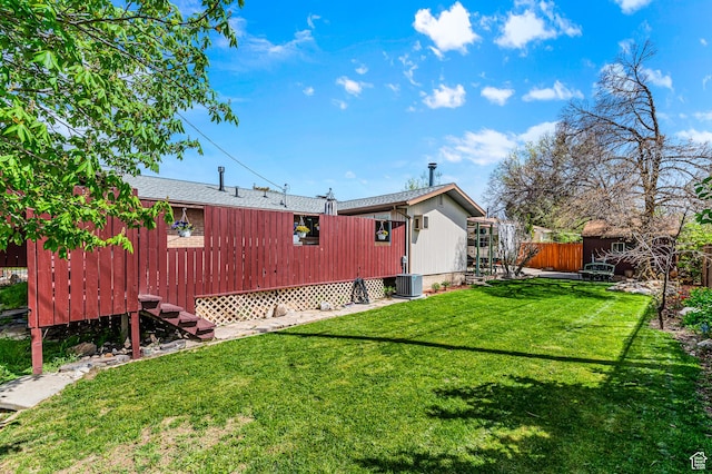 6888 S 455 E, Midvale, UT 84047 - rear view of house featuring a lawn, fence, central AC unit, and an outdoor structure