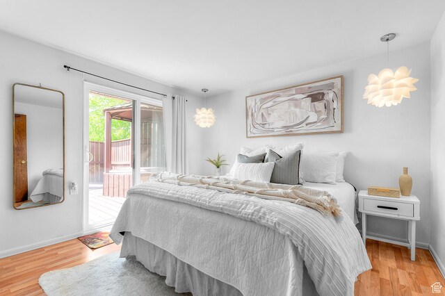 6888 S 455 E, Midvale, UT 84047 - bedroom with access to outside, baseboards, and light wood finished floors
