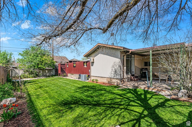6888 S 455 E, Midvale, UT 84047 - exterior space with a fenced backyard, entry steps, central air condition unit, a patio, and a yard