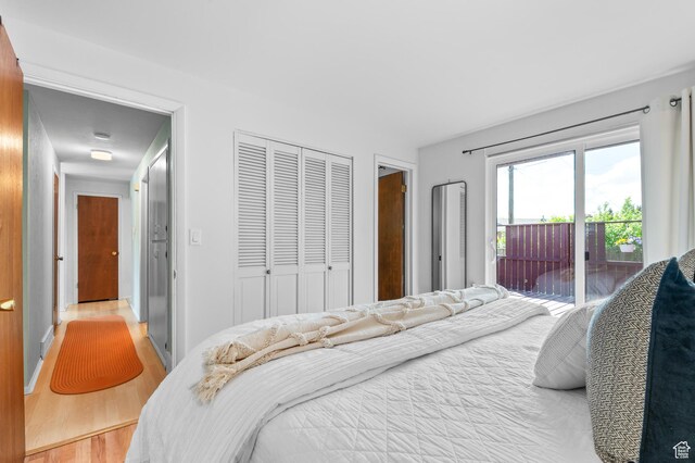 6888 S 455 E, Midvale, UT 84047 - bedroom featuring a closet, light wood-style flooring, and access to exterior