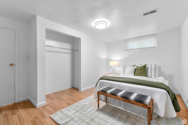 6888 S 455 E, Midvale, UT 84047 - bedroom featuring baseboards, visible vents, light wood-style flooring, and a closet