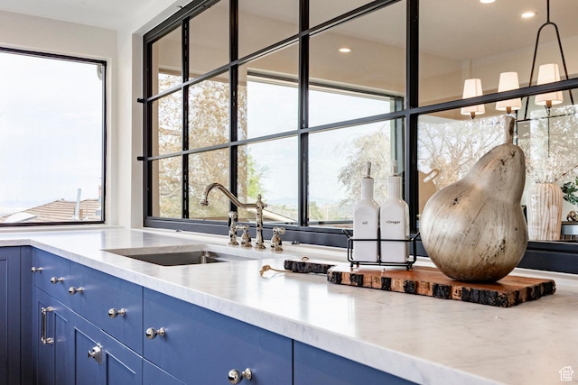 2568 E Sherwood Dr, Salt Lake City, UT 84108 - kitchen featuring light countertops, blue cabinetry, plenty of natural light, and a sink