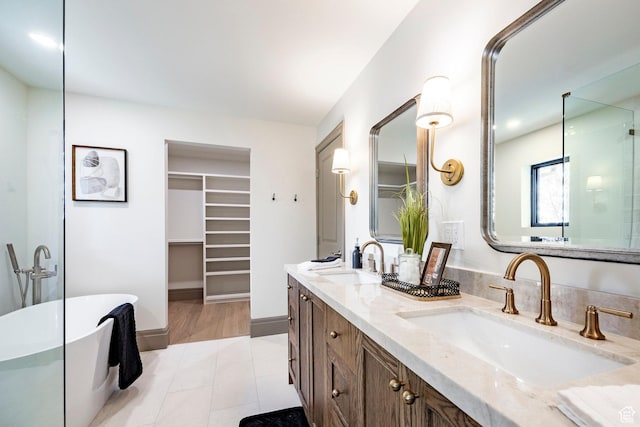 2568 E Sherwood Dr, Salt Lake City, UT 84108 - bathroom with double vanity, a sink, a freestanding tub, and a spacious closet