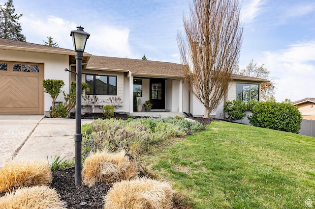 2568 E Sherwood Dr, Salt Lake City, UT 84108 - ranch-style house with an attached garage, stucco siding, driveway, and a front yard