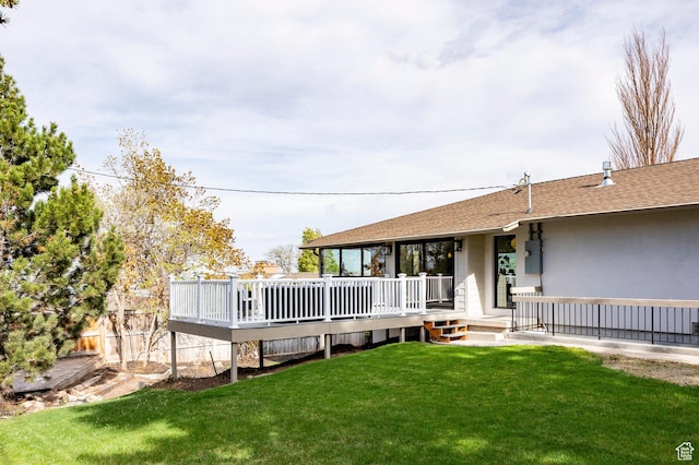 2568 E Sherwood Dr, Salt Lake City, UT 84108 - rear view of house with a yard, a deck, roof with shingles, and stucco siding