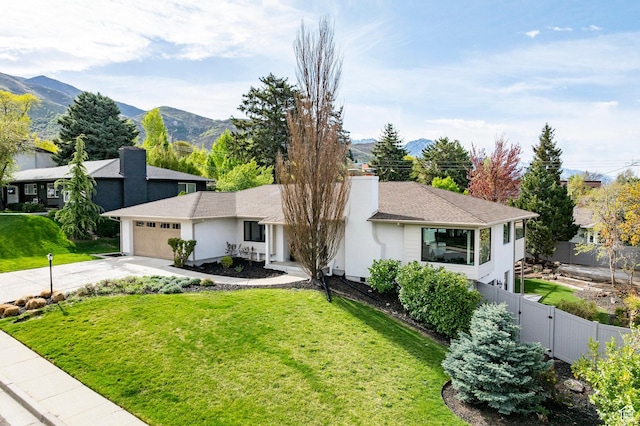 2568 E Sherwood Dr, Salt Lake City, UT 84108 - ranch-style house featuring fence, an attached garage, a front yard, a mountain view, and driveway