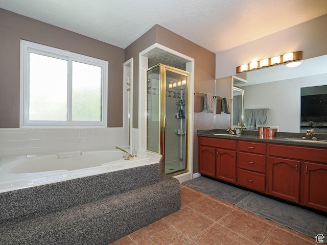 full bath featuring double vanity, a shower stall, a sink, and a bath