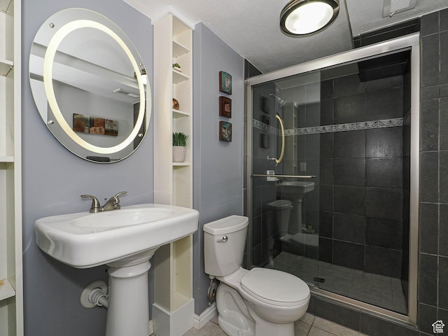 bathroom with visible vents, tile patterned flooring, a stall shower, and toilet