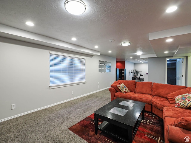 living room with baseboards, carpet, recessed lighting, and a textured ceiling