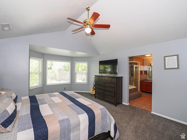 carpeted bedroom featuring a ceiling fan, visible vents, baseboards, lofted ceiling, and ensuite bathroom