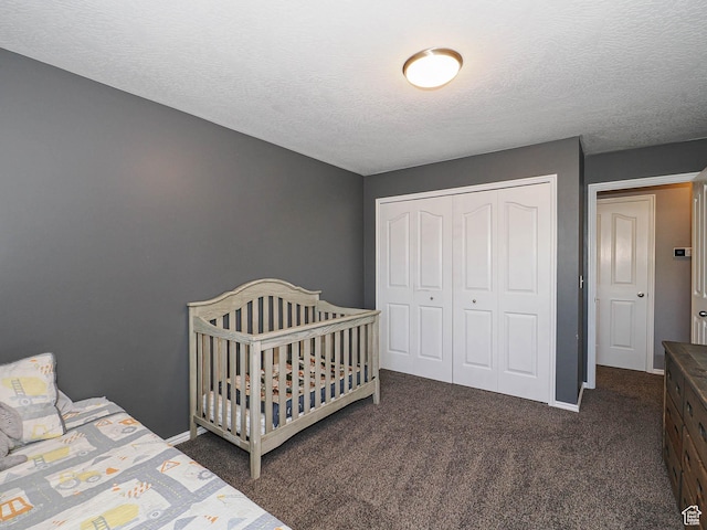carpeted bedroom featuring a closet, a textured ceiling, and baseboards