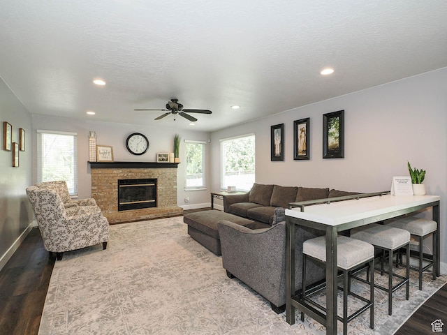 living room featuring baseboards, wood finished floors, and a wealth of natural light