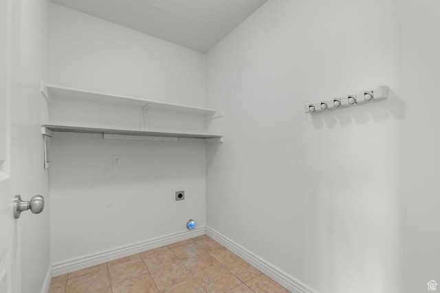 2135 N 130 W, Tooele, UT 84074 - clothes washing area featuring light tile patterned floors, baseboards, hookup for an electric dryer, and laundry area
