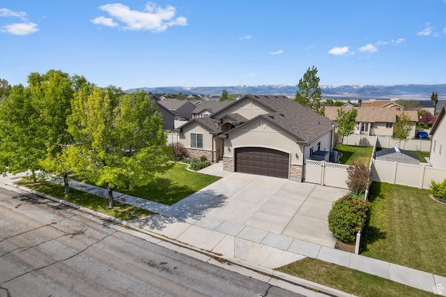 2135 N 130 W, Tooele, UT 84074 - ranch-style home with stone siding, a garage, stucco siding, a front yard, and concrete driveway
