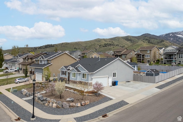 590 S 1030 E, Smithfield, UT 84335 - view of front of home with a mountain view, fence, a residential view, and concrete driveway