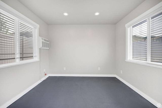590 S 1030 E, Smithfield, UT 84335 - empty room featuring baseboards, a wall mounted air conditioner, finished concrete flooring, and recessed lighting