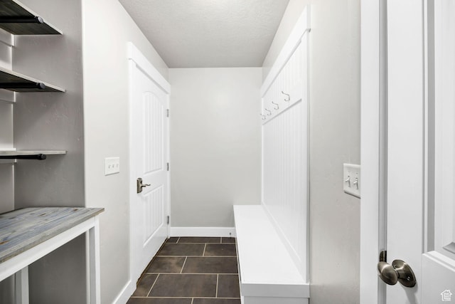 590 S 1030 E, Smithfield, UT 84335 - mudroom with dark tile patterned floors, a textured ceiling, and baseboards