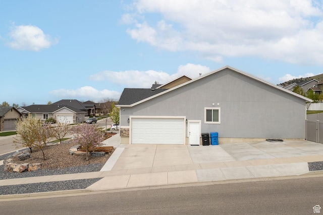 590 S 1030 E, Smithfield, UT 84335 - view of side of property featuring concrete driveway, an attached garage, and a residential view