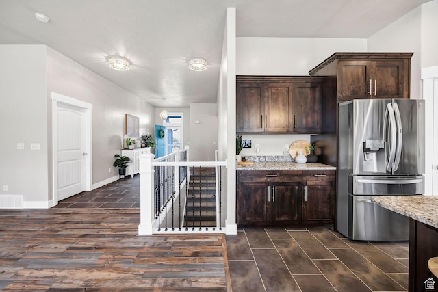 590 S 1030 E, Smithfield, UT 84335 - kitchen featuring dark brown cabinetry, light stone countertops, stainless steel fridge with ice dispenser, dark wood-type flooring, and visible vents