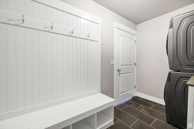 590 S 1030 E, Smithfield, UT 84335 - laundry area featuring stacked washing maching and dryer, baseboards, laundry area, and a textured ceiling