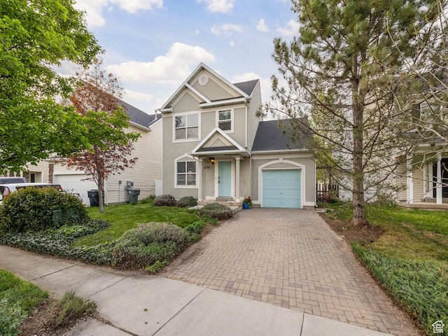 1286 W Glenbarr, Springville, UT 84663 - view of front of house featuring an attached garage, decorative driveway, and stucco siding