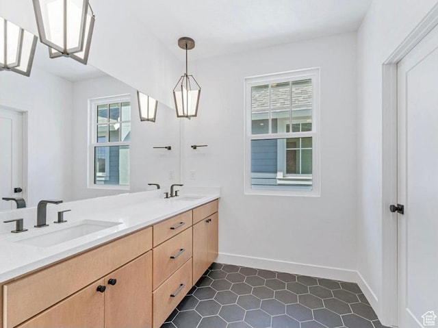11436 S Watercourse Rd Unit 110, South Jordan, UT 84009 - bathroom featuring double vanity, baseboards, a sink, and tile patterned flooring