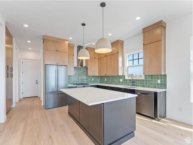 11436 S Watercourse Rd Unit 110, South Jordan, UT 84009 - kitchen with a center island, a sink, light countertops, light wood-style floors, and stainless steel appliances