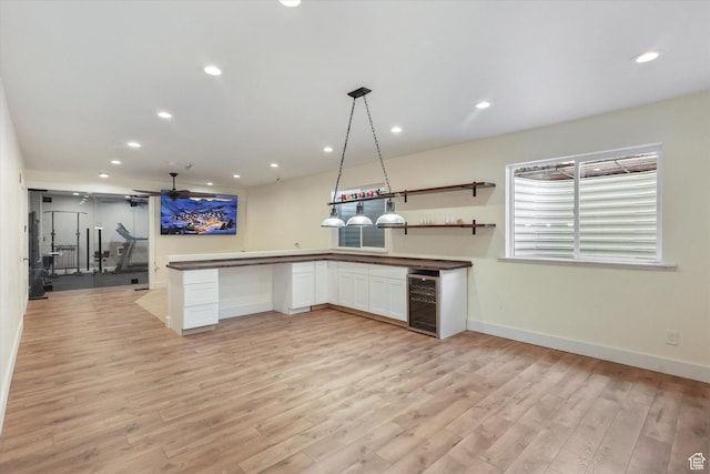 3171 N Crest Dr, Lehi, UT 84043 - kitchen with light wood-style floors, baseboards, wine cooler, recessed lighting, and white cabinetry