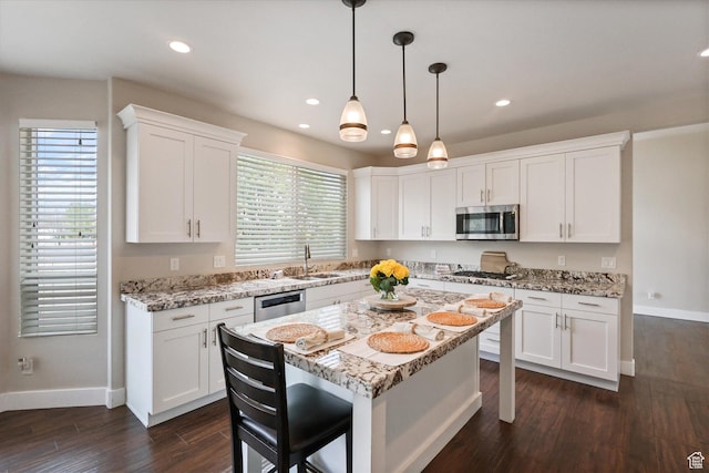 3171 N Crest Dr, Lehi, UT 84043 - kitchen with baseboards, a breakfast bar area, white cabinets, and stainless steel appliances