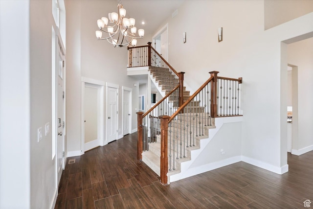 3171 N Crest Dr, Lehi, UT 84043 - foyer with a high ceiling, a chandelier, stairs, baseboards, and wood finished floors