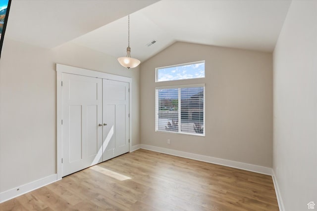 3171 N Crest Dr, Lehi, UT 84043 - unfurnished bedroom with baseboards, vaulted ceiling, light wood-style flooring, and visible vents