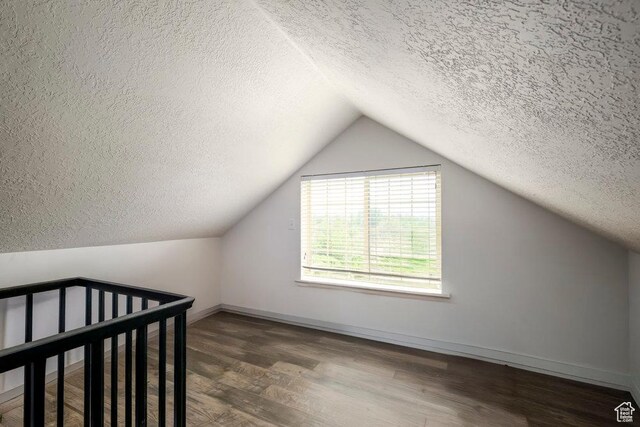 5012 S Tiimber Way Unit 415, Holladay, UT 84117 - bonus room featuring baseboards, a textured ceiling, wood finished floors, and vaulted ceiling