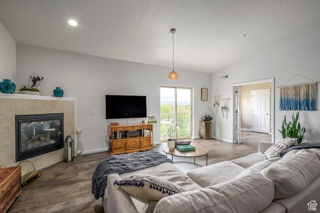 5012 S Tiimber Way Unit 415, Holladay, UT 84117 - living area with visible vents, a fireplace, wood finished floors, baseboards, and lofted ceiling