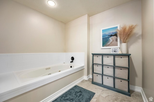 10944 S Surrey Meadow Cv, South Jordan, UT 84095 - bathroom with a tub with jets, baseboards, a textured ceiling, and vanity