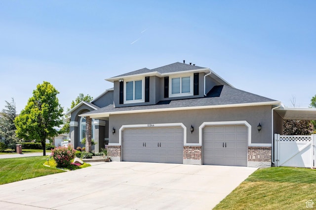10944 S Surrey Meadow Cv, South Jordan, UT 84095 - view of front facade featuring stucco siding, driveway, brick siding, a gate, and a garage