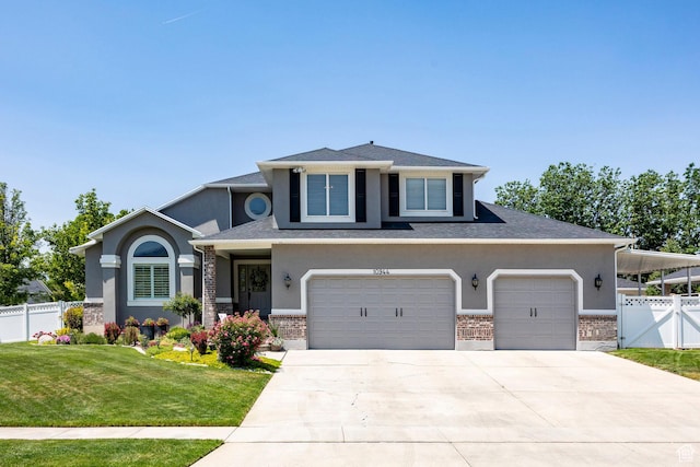 10944 S Surrey Meadow Cv, South Jordan, UT 84095 - view of front of home with driveway, stucco siding, brick siding, and a garage