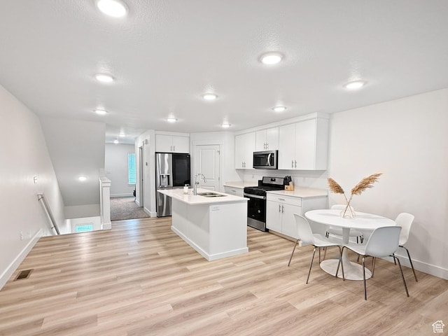 1776 N 300 E Unit 106, North Ogden, UT 84414 - kitchen featuring baseboards, light countertops, a sink, light wood finished floors, and appliances with stainless steel finishes