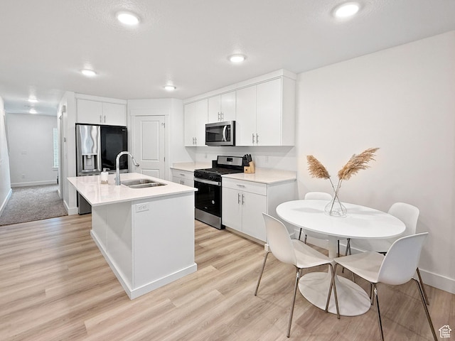 1776 N 300 E Unit 106, North Ogden, UT 84414 - kitchen with light wood-type flooring, a sink, light countertops, and stainless steel appliances