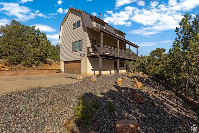375 Hillcrest, Central, UT 84722 - rear view of house featuring a garage, stucco siding, and driveway
