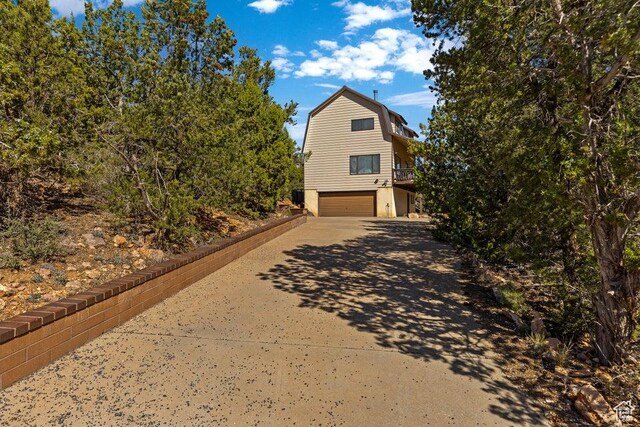 375 Hillcrest, Central, UT 84722 - view of side of home featuring a garage, a gambrel roof, and concrete driveway