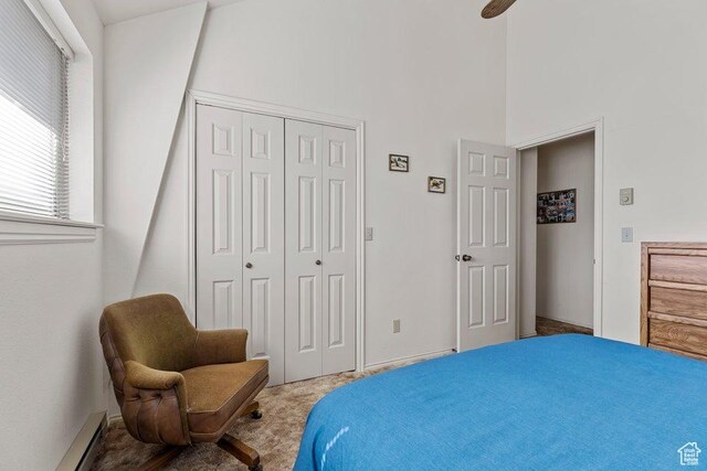 375 Hillcrest, Central, UT 84722 - bedroom featuring a closet, carpet flooring, a towering ceiling, and a baseboard heating unit
