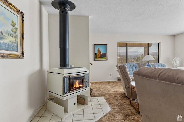 375 Hillcrest, Central, UT 84722 - living room featuring baseboards, light carpet, a wood stove, and a textured ceiling