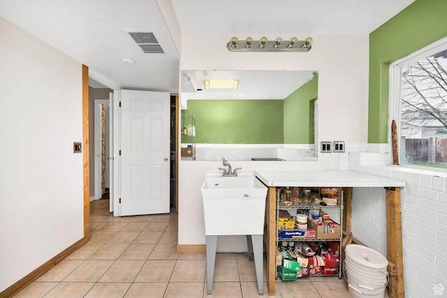 811 S Park Ave W, Logan, UT 84321 - washroom with visible vents, baseboards, and light tile patterned floors