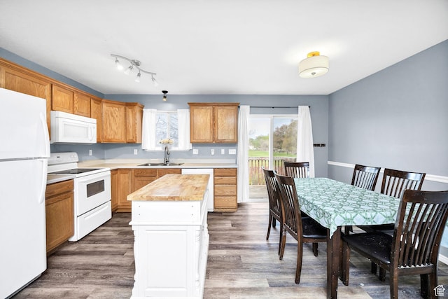 811 S Park Ave W, Logan, UT 84321 - kitchen with a sink, a kitchen island, white appliances, and wood finished floors