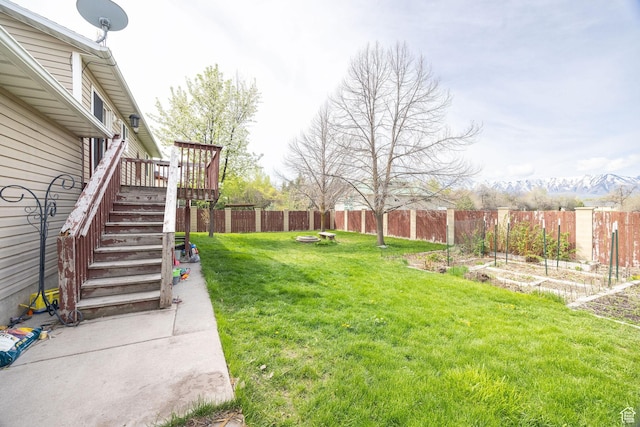 811 S Park Ave W, Logan, UT 84321 - view of yard featuring stairway, a wooden deck, a fenced backyard, and a vegetable garden