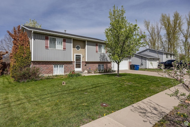 811 S Park Ave W, Logan, UT 84321 - split foyer home with a garage, a front yard, brick siding, board and batten siding, and driveway