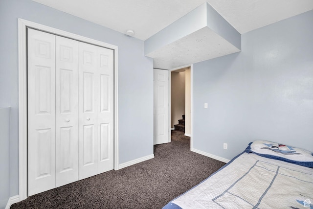 811 S Park Ave W, Logan, UT 84321 - unfurnished bedroom with dark colored carpet, baseboards, and a closet