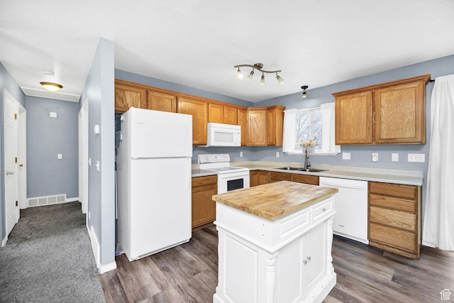 811 S Park Ave W, Logan, UT 84321 - kitchen featuring a sink, a center island, dark wood-style flooring, and white appliances